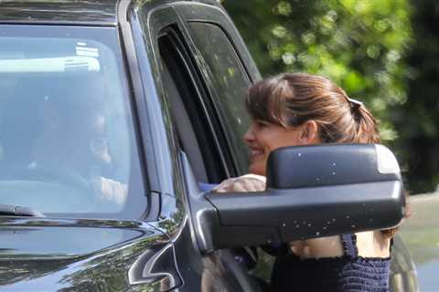 Jennifer Garner looks smitten with her boyfriend John Miller while chatting with him through the..