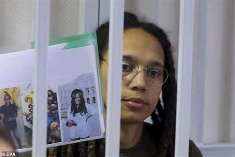 Brittney Griner holds up personal pictures as she returns to Russian court