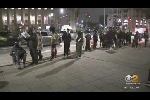 Asylum seekers line up outside immigration office