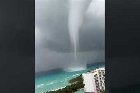 Waterspout Towers Over Shore