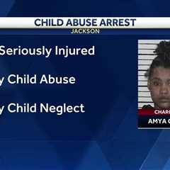 Woman charged after 1-year-old seriously injured