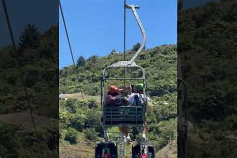 Siblings play fight on chair lift