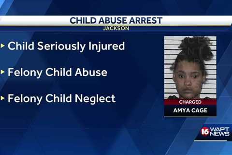 Woman charged after 1-year-old seriously injured