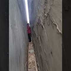 Girl Rescues Cat From Extremely Narrow Passage