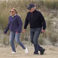 Joe Biden stumbles on sandy beach during day out in Delaware