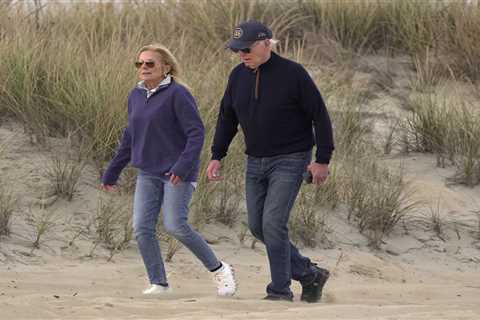 Joe Biden stumbles on sandy beach during day out in Delaware